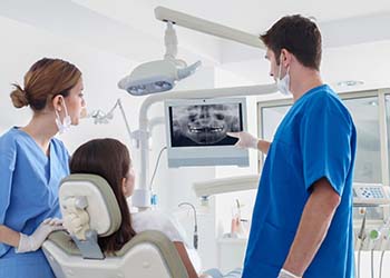 dentist showing a patient their X-rays