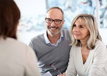 senior man and woman at a dental implant consultation