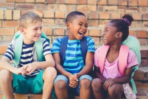 A smiling group of kids heading back to school