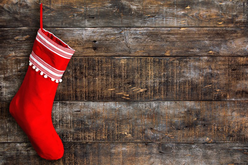 A colorful stocking against a wooden background