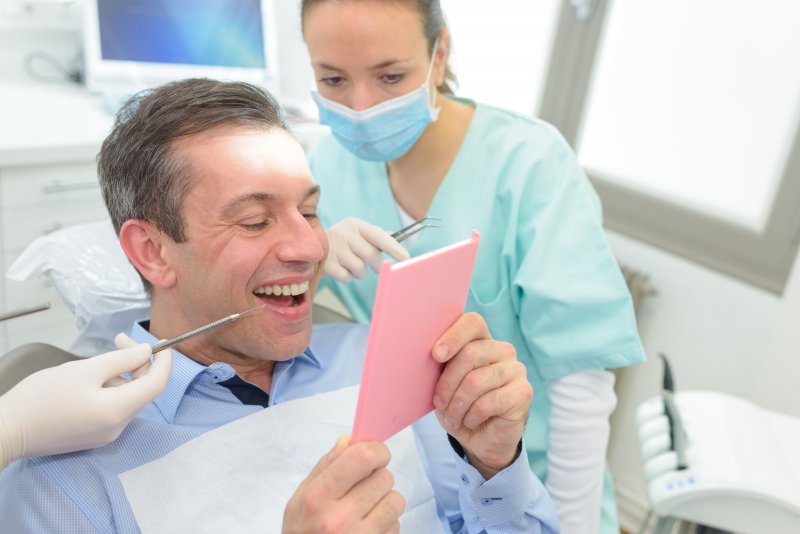 Man smiling at his dentist during his dental checkup