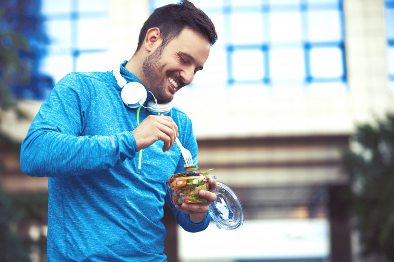 Man with good oral health eating after a workout